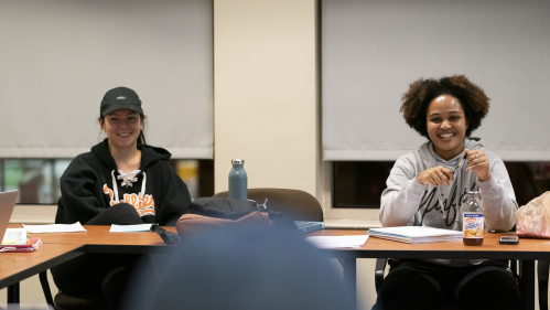 Students smiling in classroom.