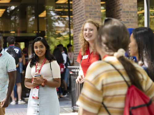 tour guide leads prospective students around campus