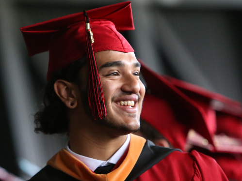 Student smiling at graduation.