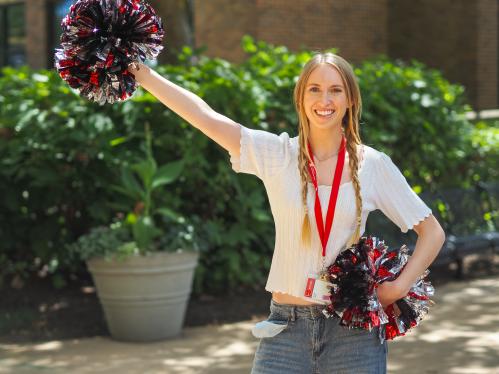 Student at orientation event with pom pom